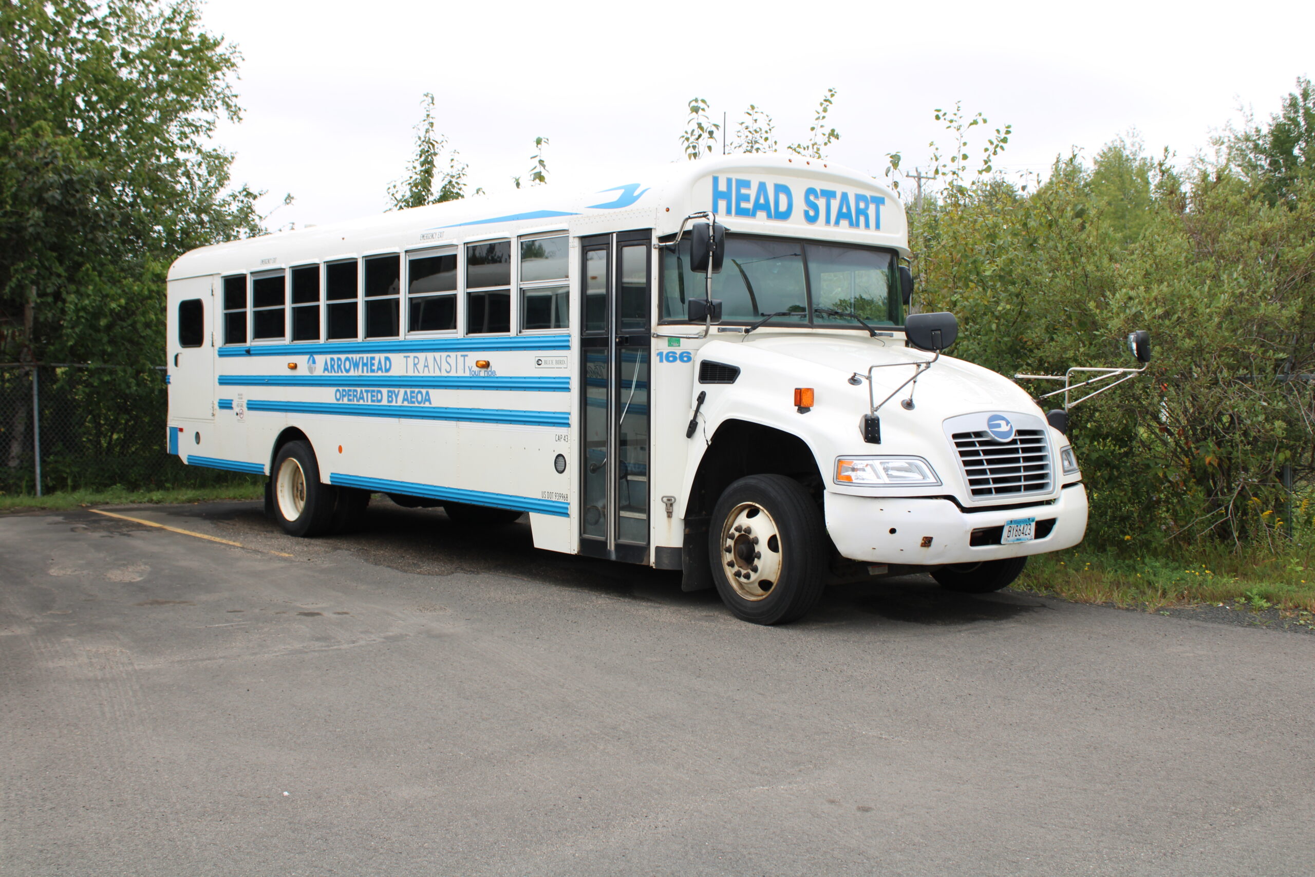 Arrowhead Transit's Head Start Program Bus: A white and blue bus with the 'Arrowhead Transit' logo prominently displayed on its side. This bus serves the Head Start Program, providing safe and reliable transportation for young children. The white and blue colors give it a clean and friendly appearance, and the logo showcases the commitment of Arrowhead Transit to community service and early childhood education.